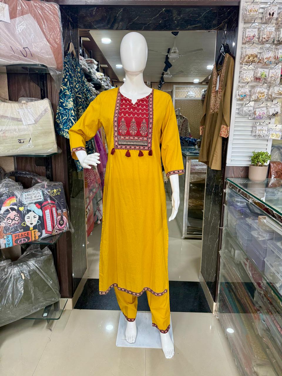 Mustard Ajrakh Print Cotton Suit With Beautiful Tasals